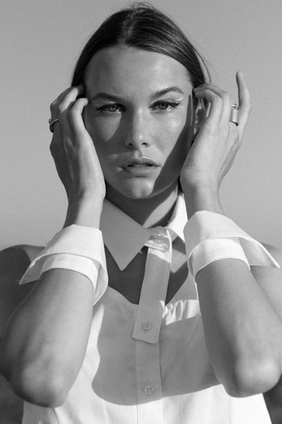 The woman in white button shirt
